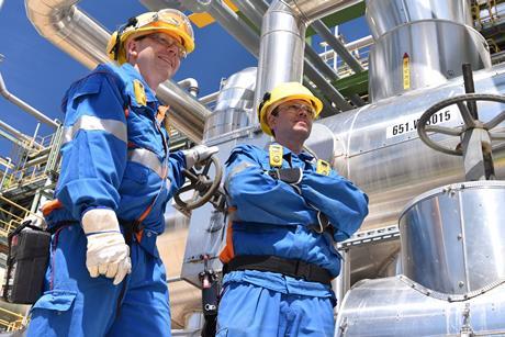 chemical industry plant - workers in work clothes