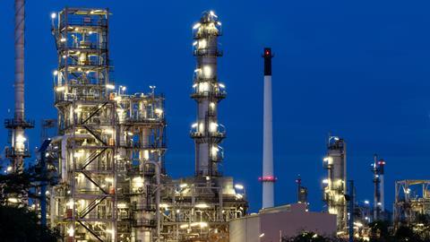 Oil and gas refinery plant firm industry zone at night.